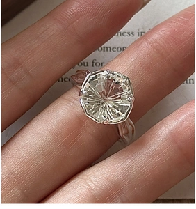 Macro shot of octagonal fireworks cut white crystal on a vintage 925 silver ring band