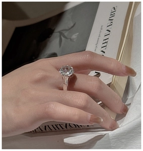 Close-up of 925 silver ring with clear crystal and textured lava band on model