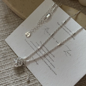 Elegant S925 sterling silver necklace featuring a heart pendant on textured paper