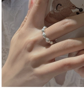 Macro shot of S925 sterling silver beaded ring with vertical texture on model's finger