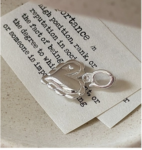 Macro view of a 925 sterling silver heart pendant with star engraving on a ceramic plate