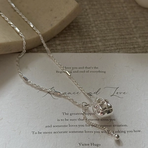 S925 sterling silver necklace with textured sphere pendant on romantic poem paper