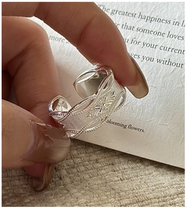 Macro shot of S925 sterling silver wide ring with vintage leaf carving and wavy edges