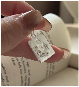 Close-up of S925 silver rectangle pendant with embossed moon star and zircon detail