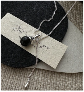 Silver long Y-shaped necklace featuring a black polished bead pendant and teardrop drop charm