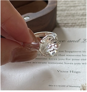 Close-up of S925 silver ring featuring a large round cut clear crystal in six-prong setting