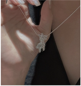 Macro view of S925 sterling silver movable horse pendant with textured stripe details