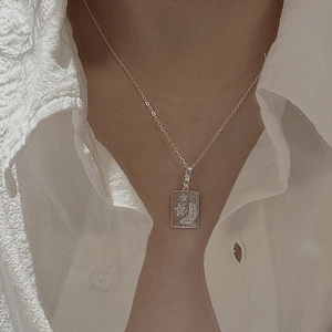 Vintage S925 sterling silver moon and star pendant necklace worn on a white linen shirt