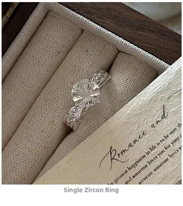 Detail showing the leaf pattern engraving on the silver ring with a round zircon