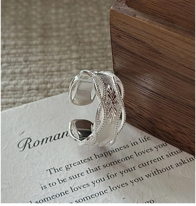 Macro shot of an S925 sterling silver vintage open ring with intricate woven textures