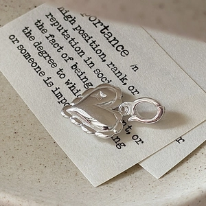 S925 sterling silver heart pendant with scallop edges and star detail on vintage background