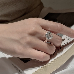 925 silver ring featuring a large round firework cut white crystal on a model's hand