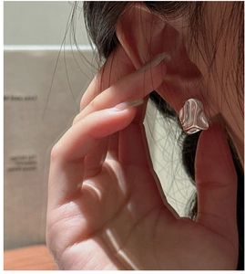 Close-up of S925 sterling silver earrings featuring a modern irregular crumpled texture