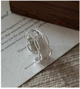 Macro shot of S925 sterling silver ring featuring intricate vintage starburst leaf carvings