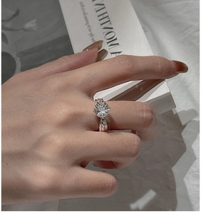 Macro shot of S925 silver ring featuring a clear crystal with spiral twisted band details