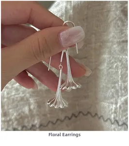 Detail of S925 silver flower earrings showing retro wavy petals and matte texture