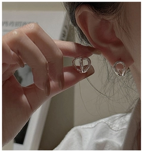 Close-up of S925 sterling silver minimalist curved hoop earrings worn on ear
