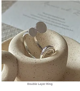 Macro detail of S925 sterling silver double-layered ring with matte circular discs