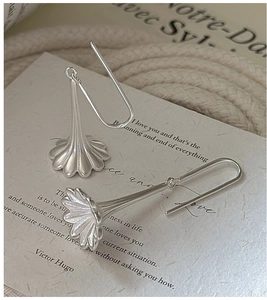 Macro detail of silver flower earrings with vintage vertical ribbed texture and matte finish