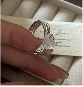 Detailed macro view of S925 sterling silver ring with white crystal and braided band design