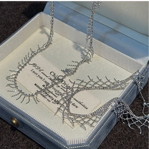 Detailed close-up of S925 sterling silver fringe necklace in a navy blue velvet jewelry box