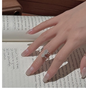 Minimalist S925 sterling silver double layer ring shown against a vintage book background