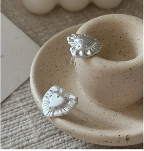 Detail of S925 silver heart stud earrings with pleated edges and tiny zircon stones