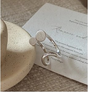 Macro detail of S925 sterling silver double layer ring with brushed geometric round disks