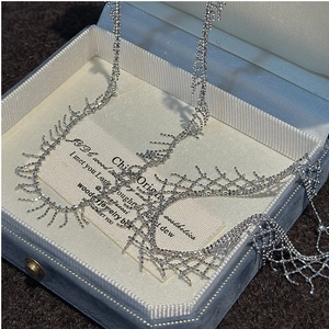 Detail of S925 silver fringe necklace with sparkling crystals in a blue velvet jewelry box