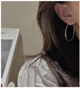 Minimalist silver hoop earrings shown on model for a trendy, everyday elegant look