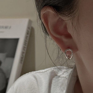 Elegant S925 sterling silver curved hoop earrings worn for a minimalist Korean fashion style