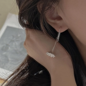 Elegant S925 sterling silver long drop earrings with vintage flower design worn by a model