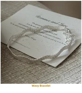 Close-up of wavy silver bracelet with vertical textures and adjustable lobster clasp