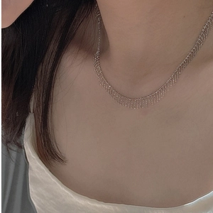 Close-up of S925 sterling silver tassel fringe necklace worn on a woman's neck