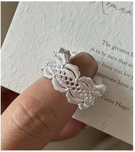 Detailed view of the vintage silver lace hollow ring with intricate woven textures on finger