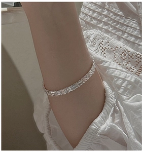 Close-up of S999 sterling silver wheat chain bracelet on wrist with minimalist retro style