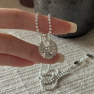 925 sterling silver necklace with textured round disc pendant on a fine bead chain