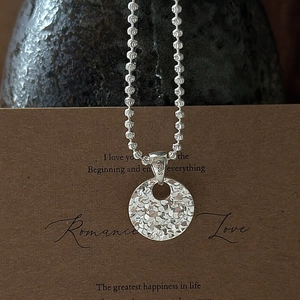 925 sterling silver necklace with textured round disc pendant and bead chain detail
