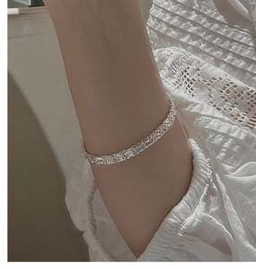 Detailed close-up of S999 sterling silver woven foxtail chain bracelet on a wrist
