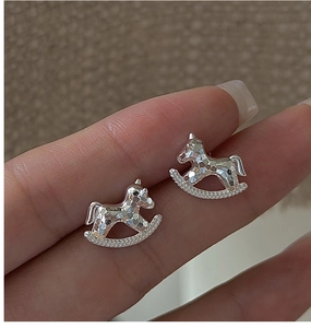 Macro shot of S925 sterling silver rocking horse studs with sparkling ice-crushed texture