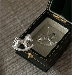 Detailed close-up of S925 sterling silver rocking horse earrings with hammered texture