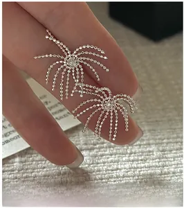 Macro detail of S925 silver fringe fireworks earrings with shimmering rhinestones