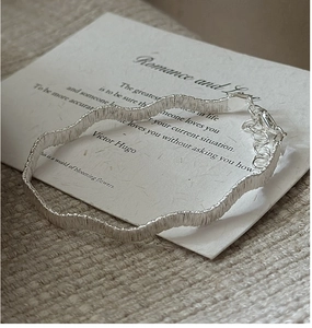 Detail of S925 sterling silver woven wave bracelet with lobster clasp and extender chain