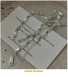 Macro detail of S925 sterling silver infinity link chain with AG925 hallmark on tag