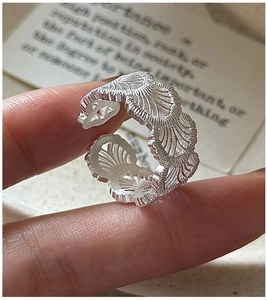 Macro detail of S925 sterling silver ring with delicate lace texture and matte finish