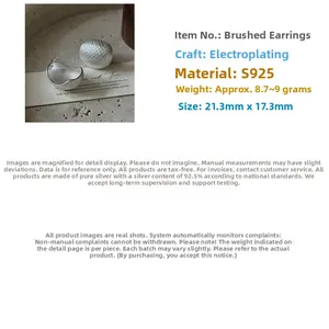 Macro detail of S925 sterling silver earrings with brushed texture and pebble shape