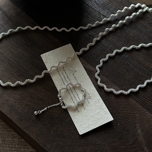 S925 sterling silver wave twisted necklace and open ring set on vintage wood background