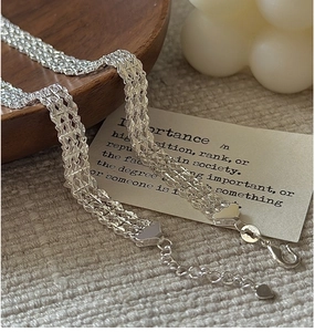Détail du bracelet multicouche tressé en argent S925 avec breloque en cœur