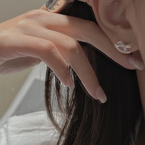 Minimalist S925 sterling silver rocking horse stud earrings worn on a female ear model