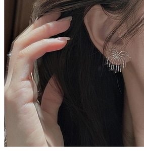 Detailed close-up of S925 silver fringe fireworks earrings worn by a female model